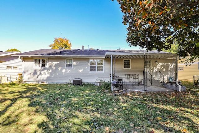 rear view of house with a patio area, central AC unit, and a lawn