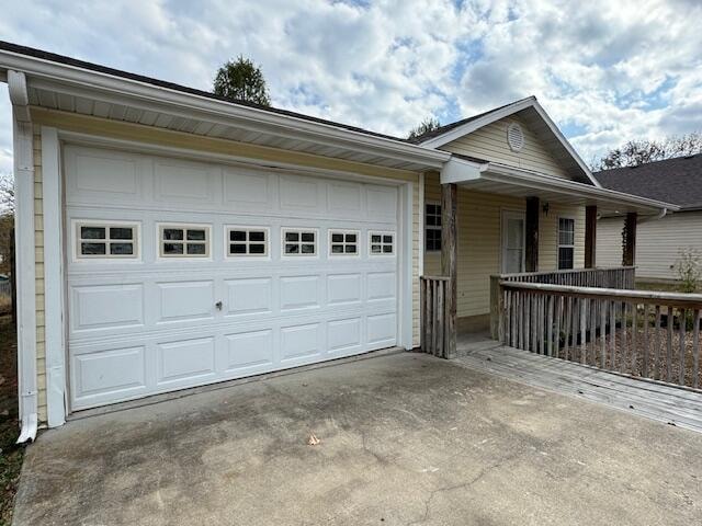 single story home featuring covered porch and a garage