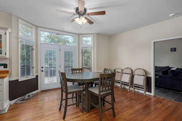 dining room with ceiling fan, a textured ceiling, and light hardwood / wood-style flooring