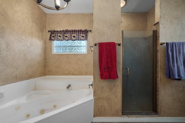 bathroom with a textured ceiling and independent shower and bath