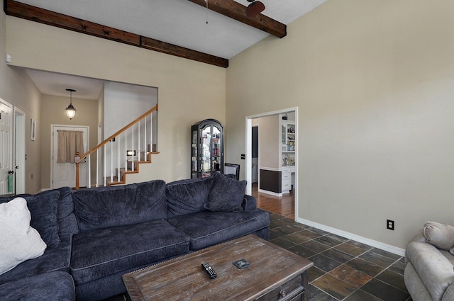 living room featuring beam ceiling and high vaulted ceiling