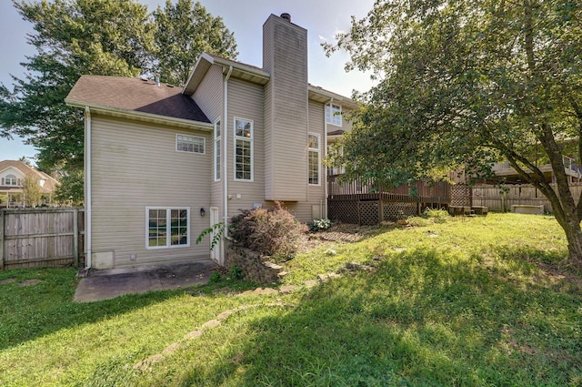 back of property featuring a yard and a patio