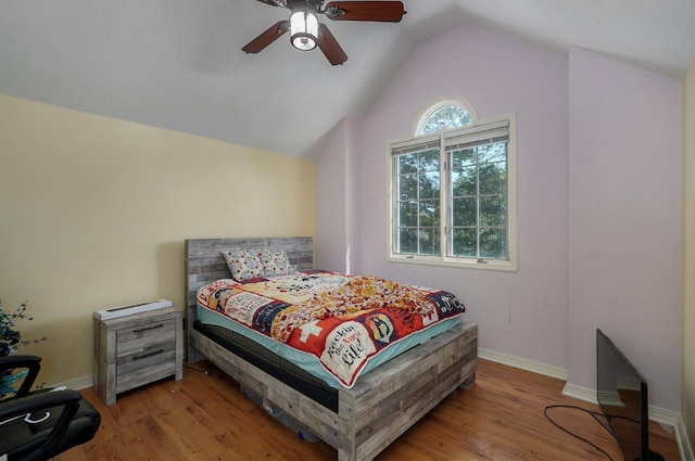 bedroom featuring ceiling fan, vaulted ceiling, and light hardwood / wood-style flooring