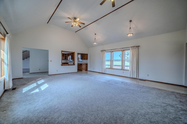 unfurnished living room with a ceiling fan, visible vents, high vaulted ceiling, baseboards, and carpet flooring