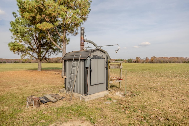 view of outbuilding featuring a yard and a rural view