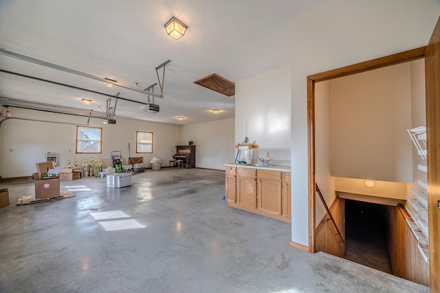 garage with a garage door opener and sink