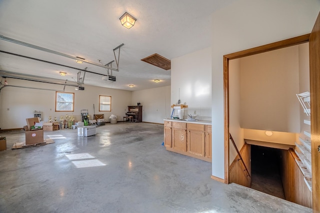 garage with baseboards and a garage door opener