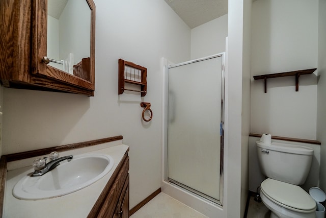 bathroom featuring vanity, toilet, and a shower with shower door