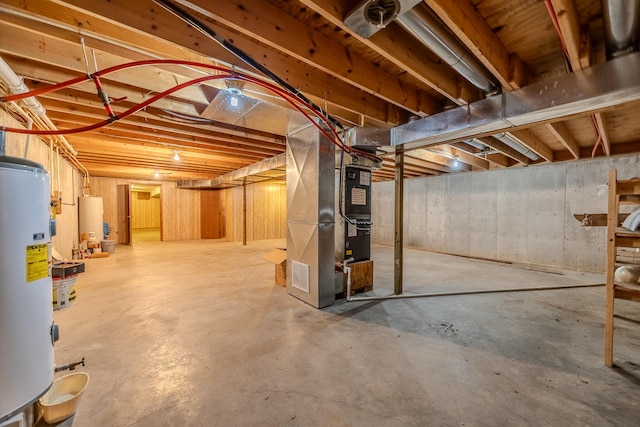 basement with water heater, gas water heater, and heating unit