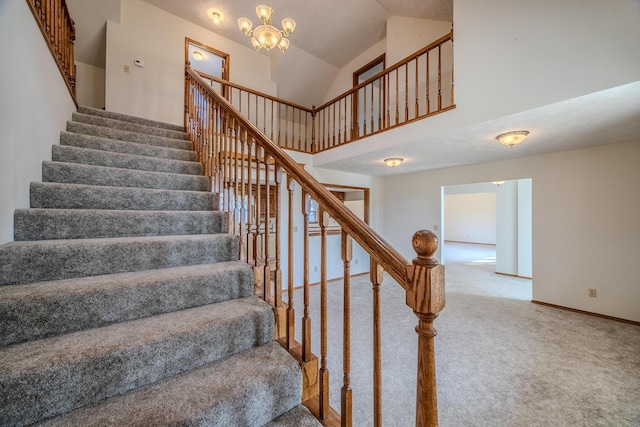staircase with carpet flooring, baseboards, a chandelier, and high vaulted ceiling