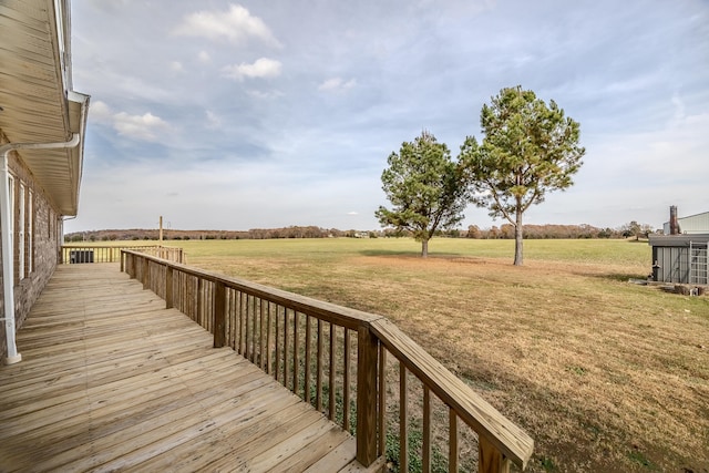 wooden deck featuring a yard and a rural view