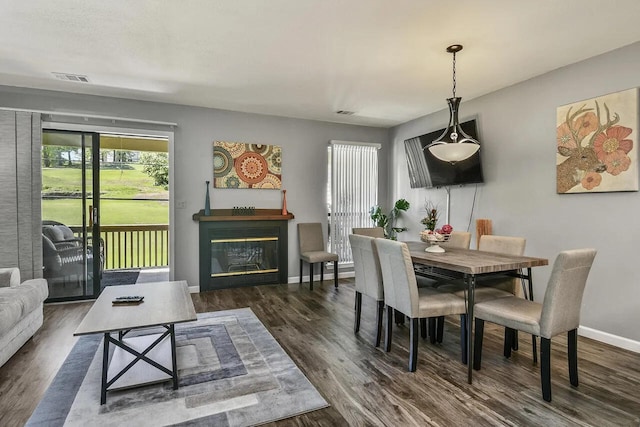 dining area featuring dark wood-type flooring