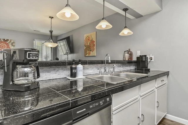 kitchen featuring hanging light fixtures, white cabinetry, wood-type flooring, dishwasher, and sink