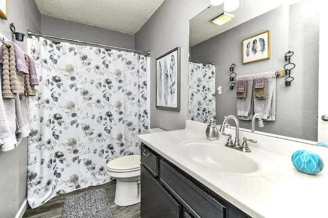 bathroom featuring a textured ceiling, wood-type flooring, toilet, vanity, and a shower with shower curtain