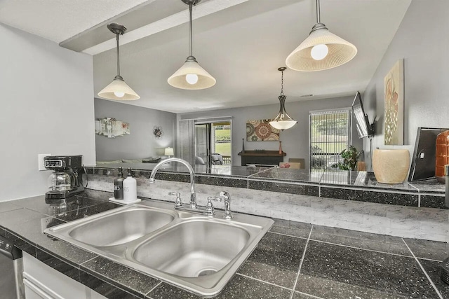 kitchen with sink, a wealth of natural light, and hanging light fixtures