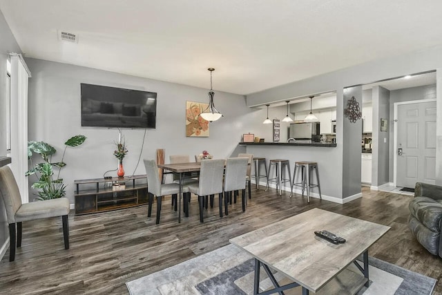 dining area with dark wood-type flooring