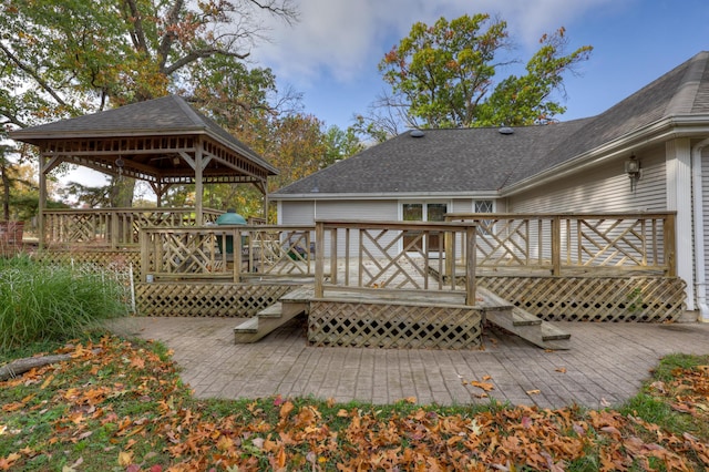 back of property with a gazebo and a wooden deck