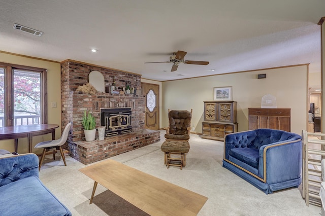 carpeted living room featuring ceiling fan, a textured ceiling, a wood stove, and ornamental molding