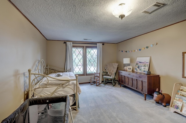 bedroom featuring crown molding, a textured ceiling, and light colored carpet