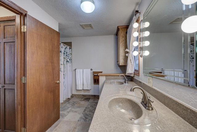 bathroom featuring vanity and a textured ceiling