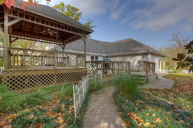 exterior space with a wooden deck and ceiling fan