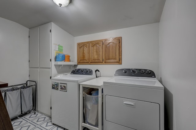 laundry room with cabinets and washer and dryer