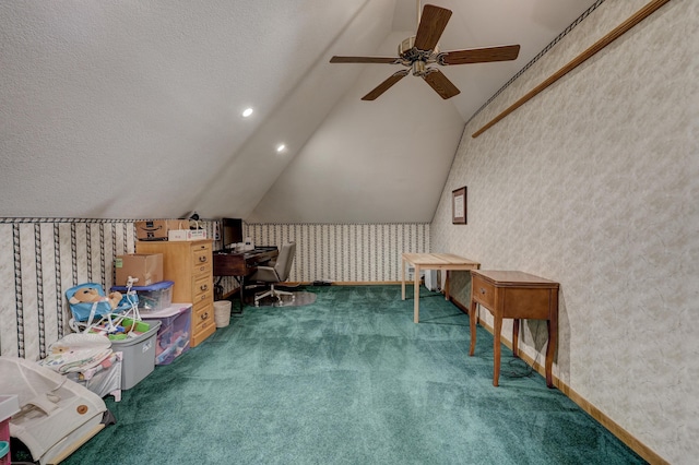 interior space featuring ceiling fan, a textured ceiling, vaulted ceiling, and dark carpet