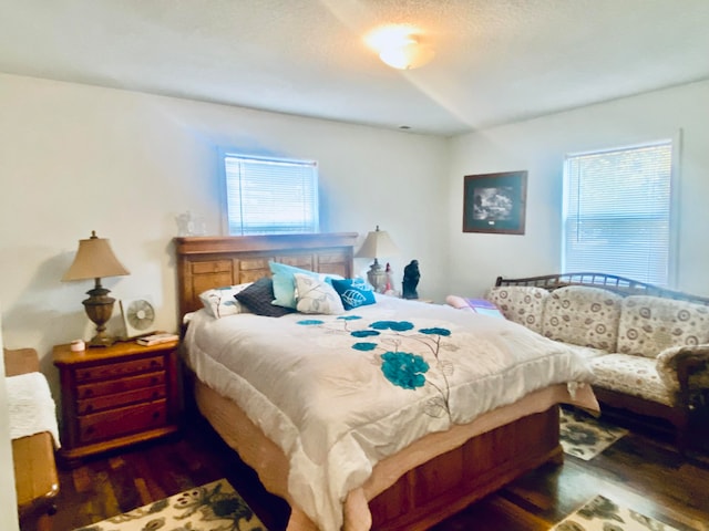 bedroom with dark wood-type flooring