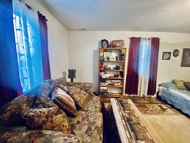 bedroom featuring multiple windows, wood finished floors, and visible vents