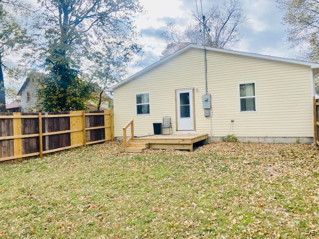 back of house with a yard and a wooden deck