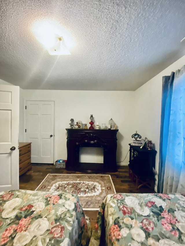 bedroom featuring a textured ceiling and wood finished floors
