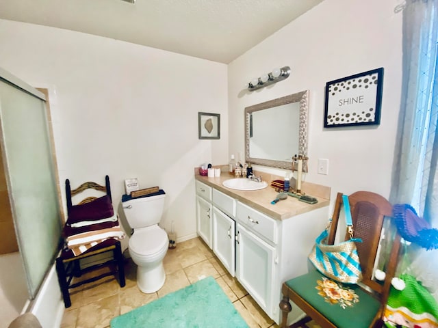 bathroom featuring vanity, toilet, and tile patterned flooring