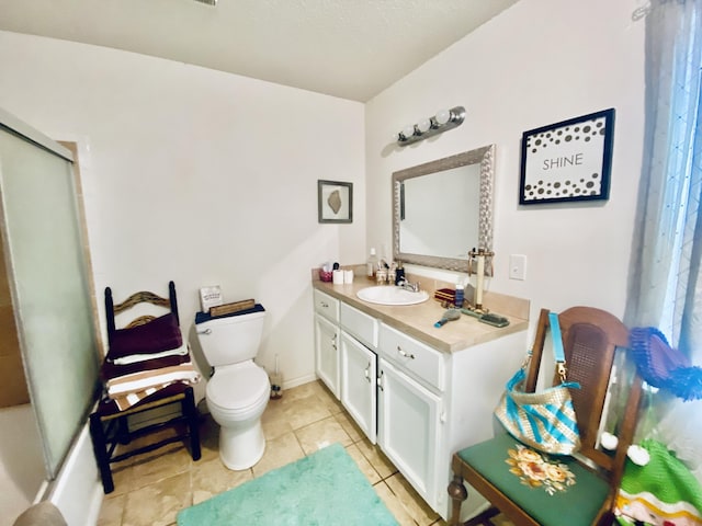 bathroom with toilet, tile patterned flooring, and vanity