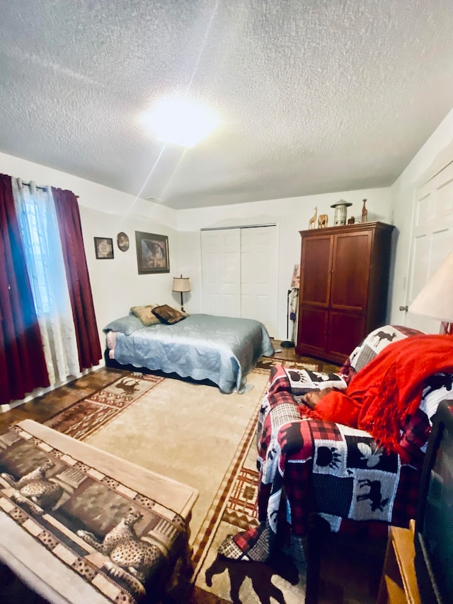 carpeted bedroom featuring a closet and a textured ceiling