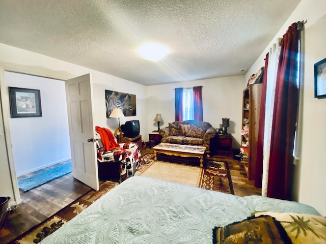 bedroom featuring a textured ceiling and dark wood-type flooring