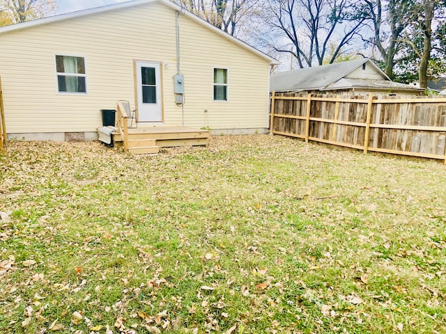 rear view of house with a yard