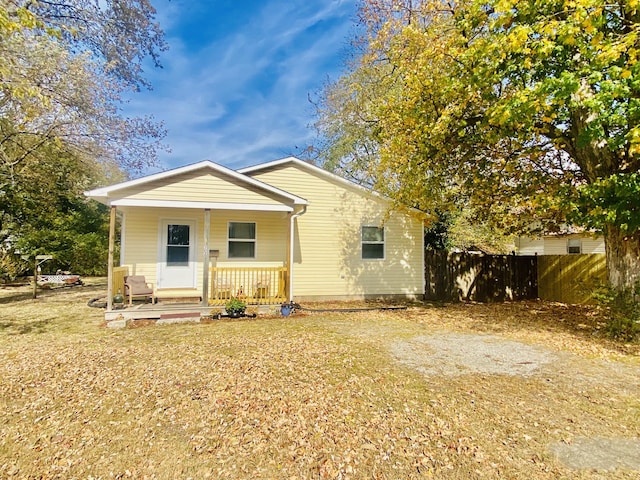 view of front facade with a porch and fence