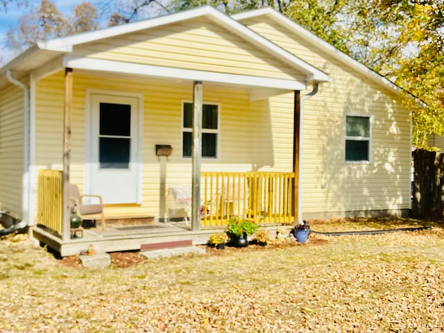 back of property featuring covered porch