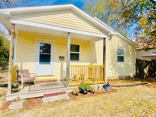 rear view of house featuring a porch