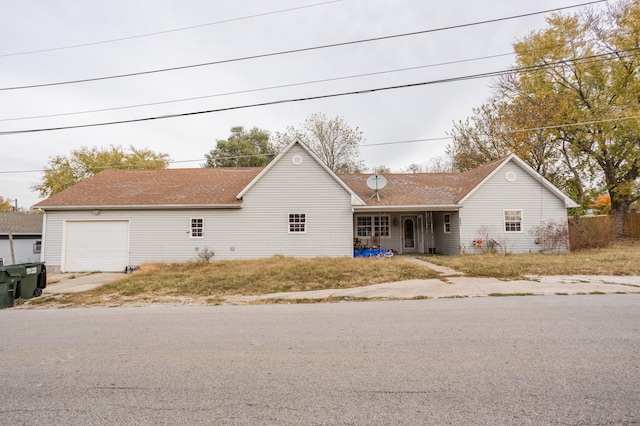 ranch-style home with covered porch and a garage