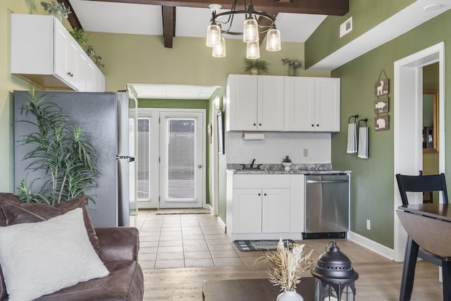 kitchen with white cabinetry, dishwasher, and light hardwood / wood-style flooring