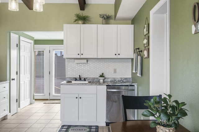 kitchen with dishwasher, white cabinetry, and sink