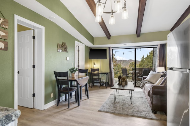 living room with beam ceiling, a chandelier, and light wood-type flooring