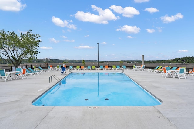 view of swimming pool with a patio