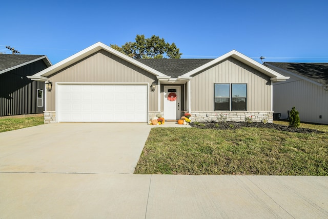 view of front of house with a garage and a front lawn