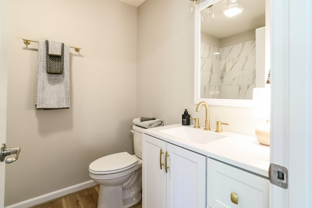 bathroom with vanity, toilet, wood-type flooring, and a tile shower