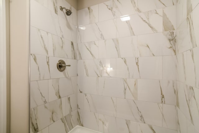 bathroom with tiled shower