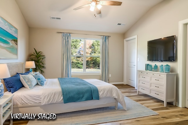 bedroom featuring lofted ceiling, light hardwood / wood-style flooring, and ceiling fan