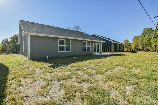 rear view of property with a patio area and a lawn