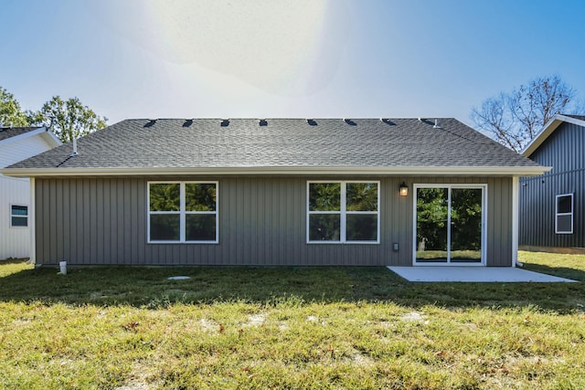 rear view of property with a patio and a lawn